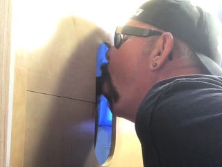 Gloryhole hunk eagerly sucking bbc dick through wall