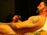 Hairy bear jacking on bed