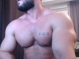 Hot muscled tanned gay hunk taking a shower