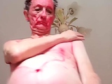 old guy painting himself red and dances nude