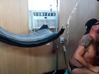 Interracial mature gay gets fucked in sling at home